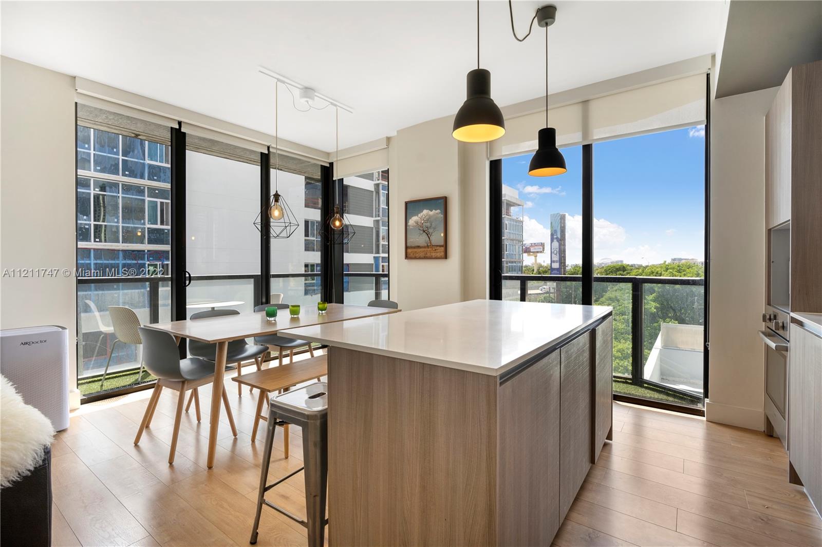 201 Southwest 17th Road, Unit 501 Miami, FL 33129 - Photo 4 of 21 a kitchen with a table chairs and white appliances