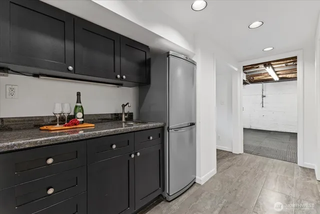 a kitchen with sink a refrigerator and cabinets