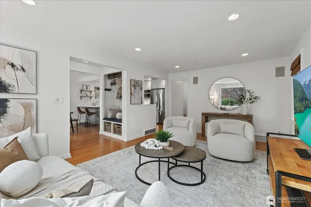 a living room with furniture a rug and a table