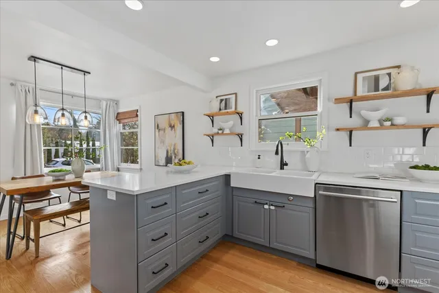 a kitchen with a sink stove and cabinets
