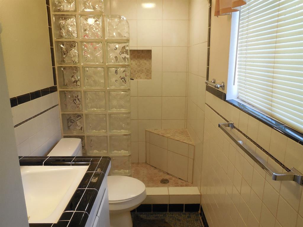 209 Breckenridge Road Ranger, TX 76470 - Photo 17 of 21 a bathroom with a sink toilet and shower