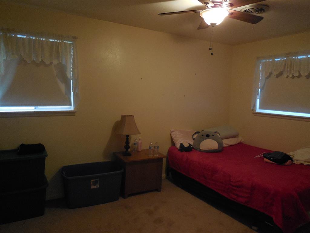 209 Breckenridge Road Ranger, TX 76470 - Photo 18 of 21 a bedroom with a bed and a window