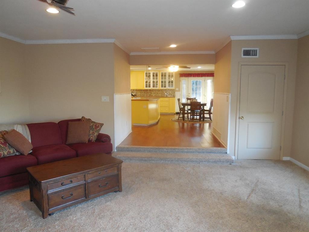 209 Breckenridge Road Ranger, TX 76470 - Photo 19 of 21 a living room with furniture and a dining table with kitchen view