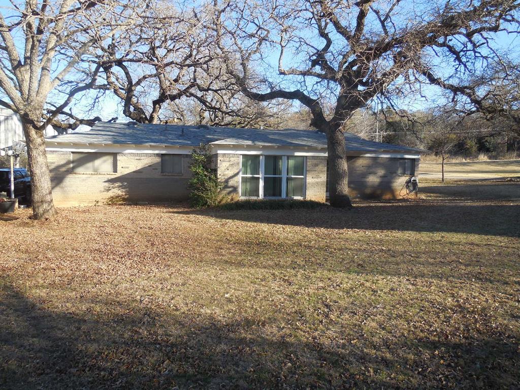 209 Breckenridge Road Ranger, TX 76470 - Photo 2 of 21 a front view of house with yard and trees around