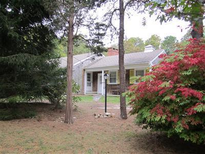 87 Foster Road Brewster, MA 02631 - Photo 11 of 15 a front view of a house with a yard and tree
