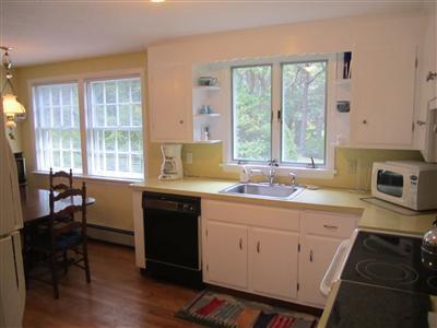 87 Foster Road Brewster, MA 02631 - Photo 4 of 15 a kitchen with a sink stove and cabinets