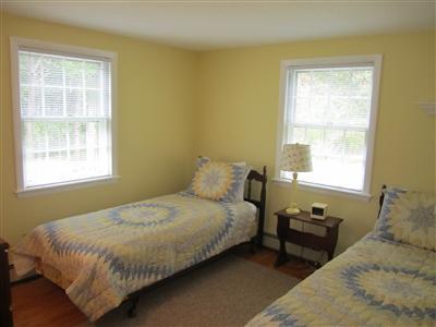 87 Foster Road Brewster, MA 02631 - Photo 9 of 15 a bedroom with a bed and wooden floor