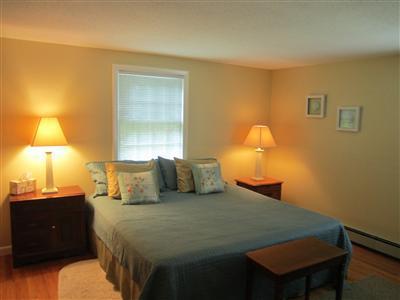 87 Foster Road Brewster, MA 02631 - Photo 10 of 15 a bedroom with a bed and a lamp