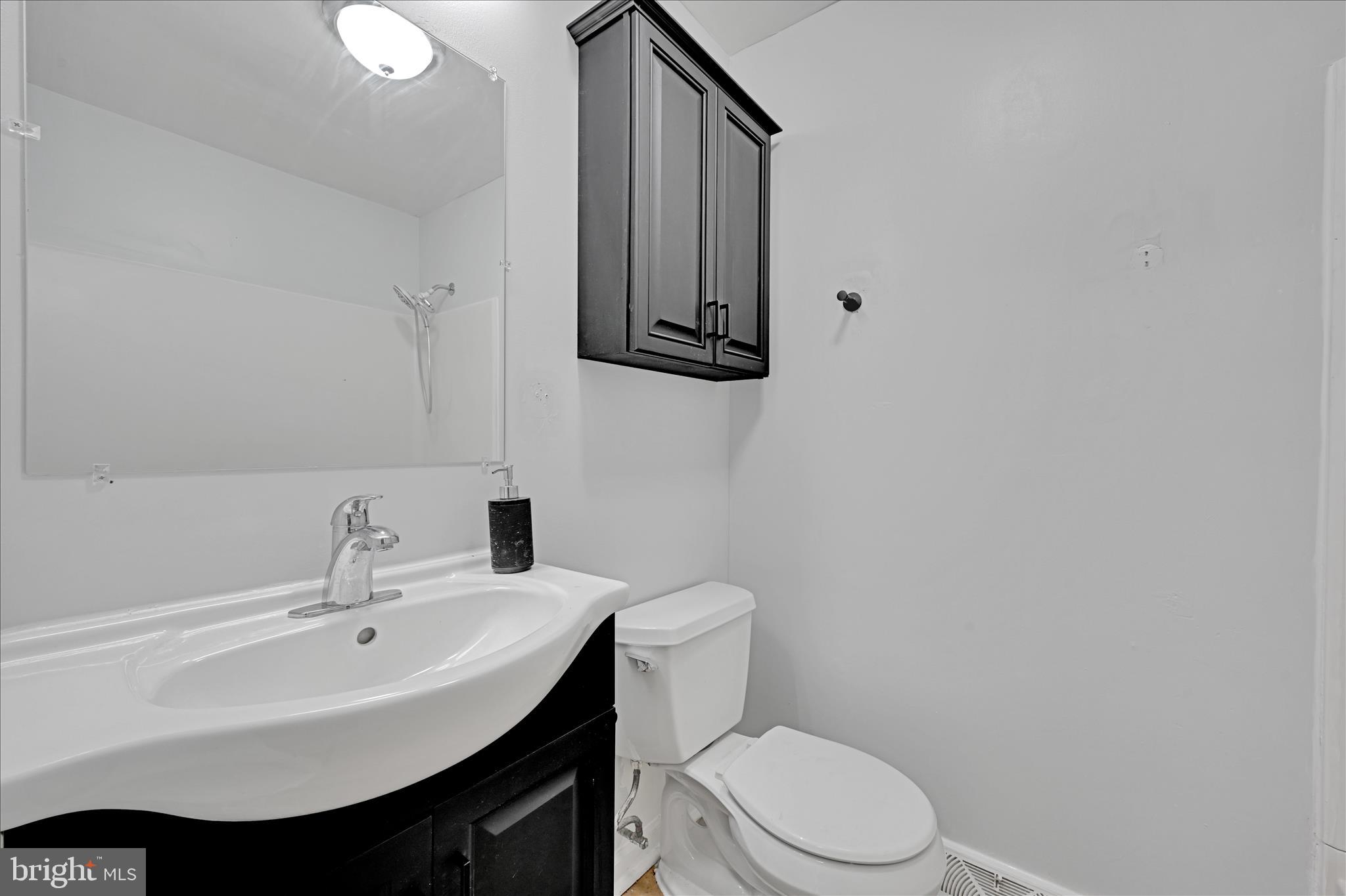 465 Pleasant View Road New Cumberland, PA 17070 - Photo 16 of 31 a bathroom with a sink toilet and mirror