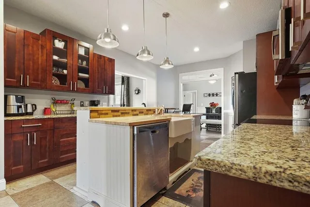 a kitchen with stainless steel appliances granite countertop a sink and cabinets
