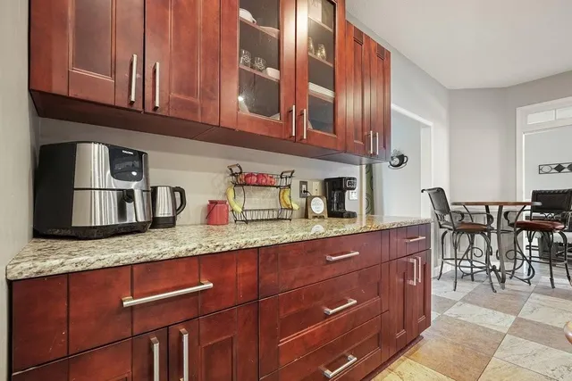 a kitchen with stainless steel appliances kitchen island granite countertop a refrigerator oven a sink and dishwasher