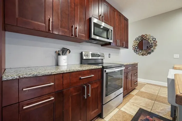 a kitchen with a refrigerator a microwave and furniture