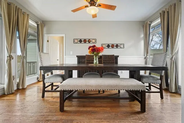 a view of a workspace with furniture window and wooden floor