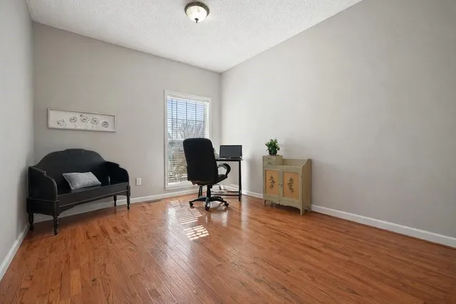 a bathroom with a granite countertop sink a washing machine and a mirror