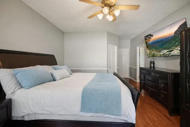 a bedroom with a bed and wooden floor