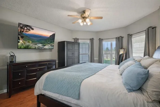 a bedroom with a bed and a flat screen tv