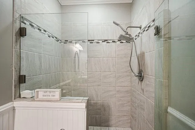 a bathroom with a double vanity sink a mirror and a bathtub