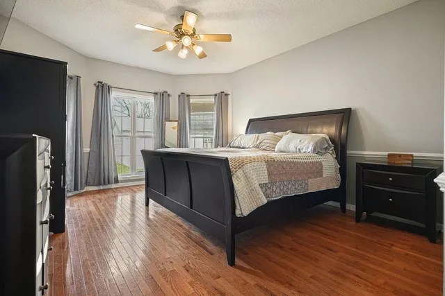 a bathroom with a granite countertop sink and a bathtub