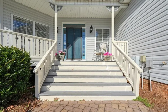 a view of entryway with wooden floor and a front door