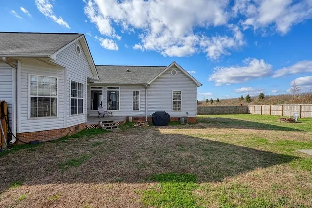 a view of white house with a yard