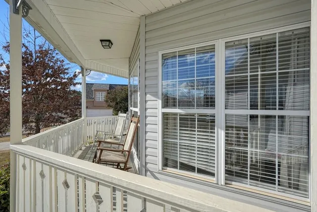 a view of a room with wooden floor and a potted plant