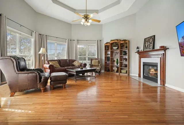 a living room with furniture a fireplace and a flat screen tv