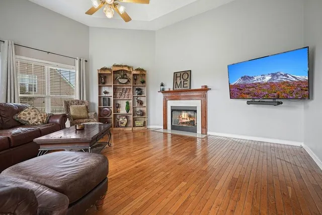 a living room with furniture a fireplace and a flat screen tv