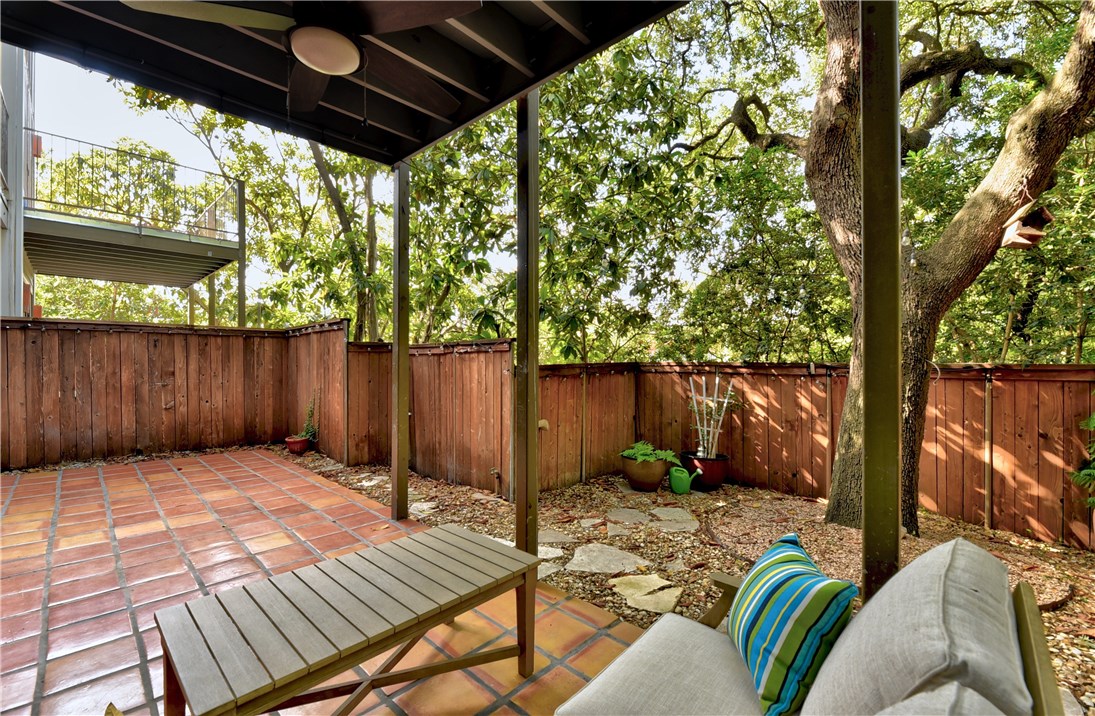 a view of backyard with a patio and wooden fence
