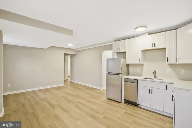 a kitchen with stainless steel appliances granite countertop a refrigerator sink and stove