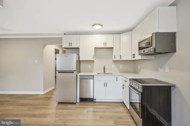a kitchen with stainless steel appliances a refrigerator and a stove top oven