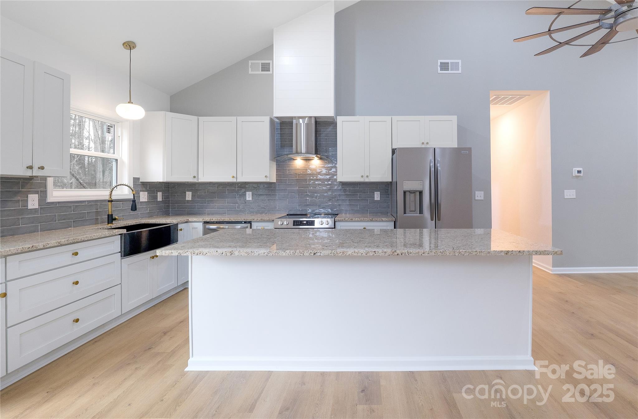 203 Bud Black Road Crouse, NC 28033 - Photo 11 of 47 a kitchen with stainless steel appliances white cabinets a sink a stove a refrigerator and island