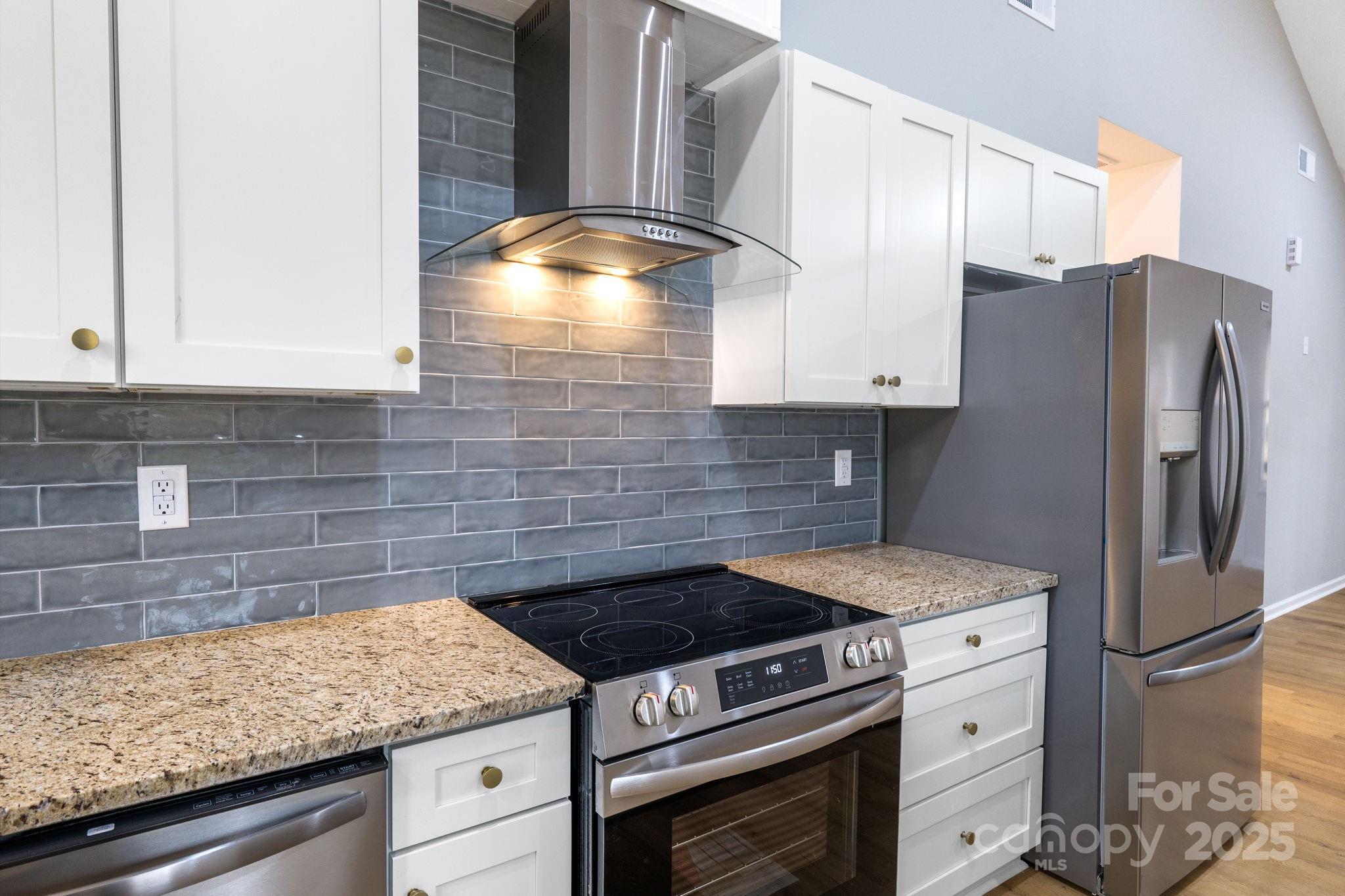 203 Bud Black Road Crouse, NC 28033 - Photo 13 of 47 a kitchen with stainless steel appliances granite countertop a sink stove and refrigerator