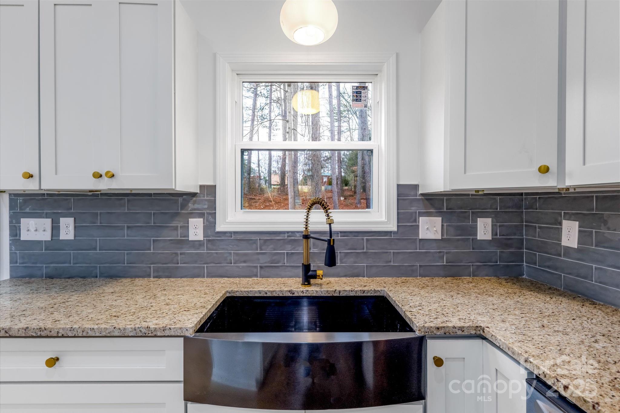 203 Bud Black Road Crouse, NC 28033 - Photo 14 of 47 a kitchen with granite countertop a sink and white cabinets