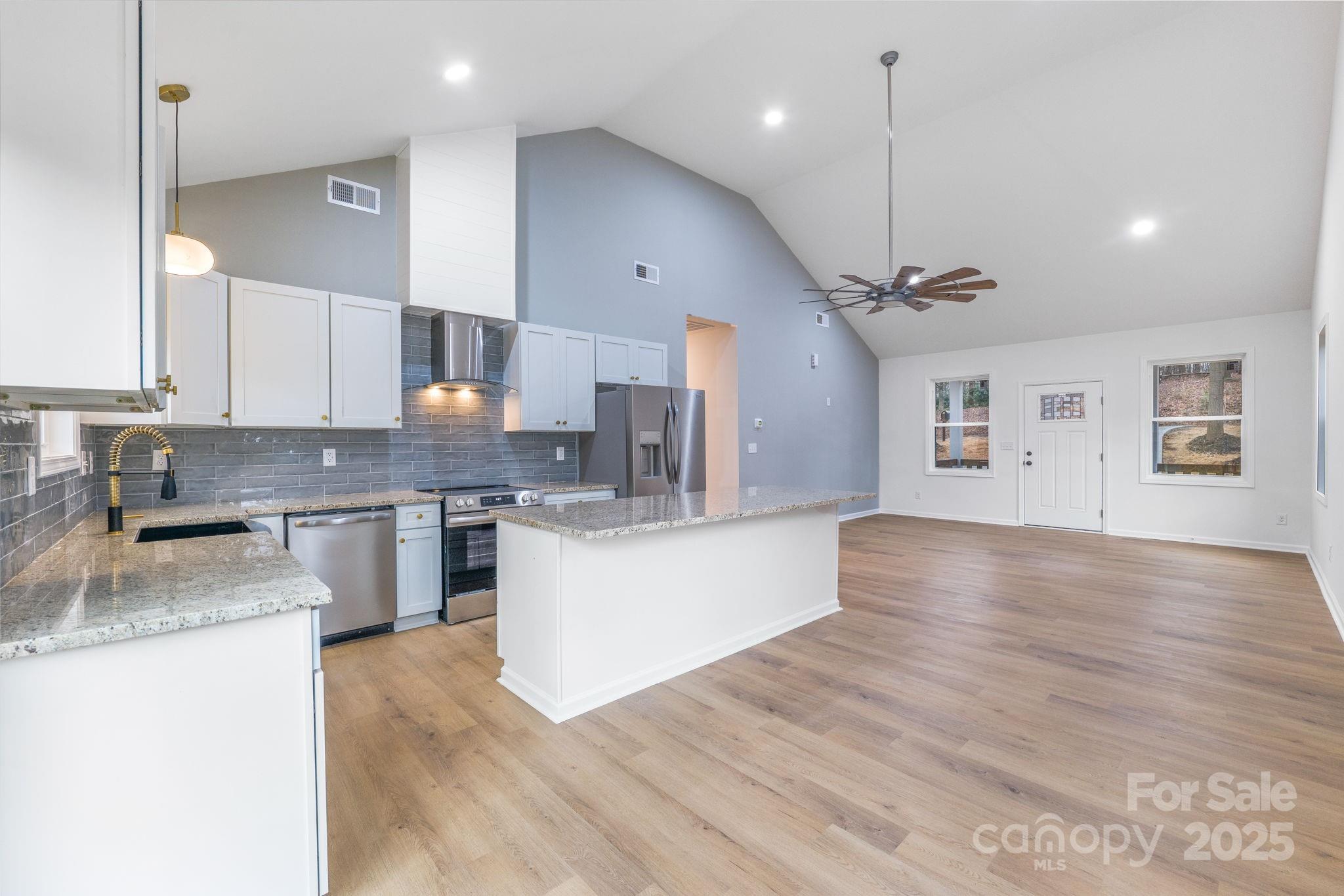 203 Bud Black Road Crouse, NC 28033 - Photo 23 of 47 a large kitchen with stainless steel appliances granite countertop a sink a stove and a wooden floors