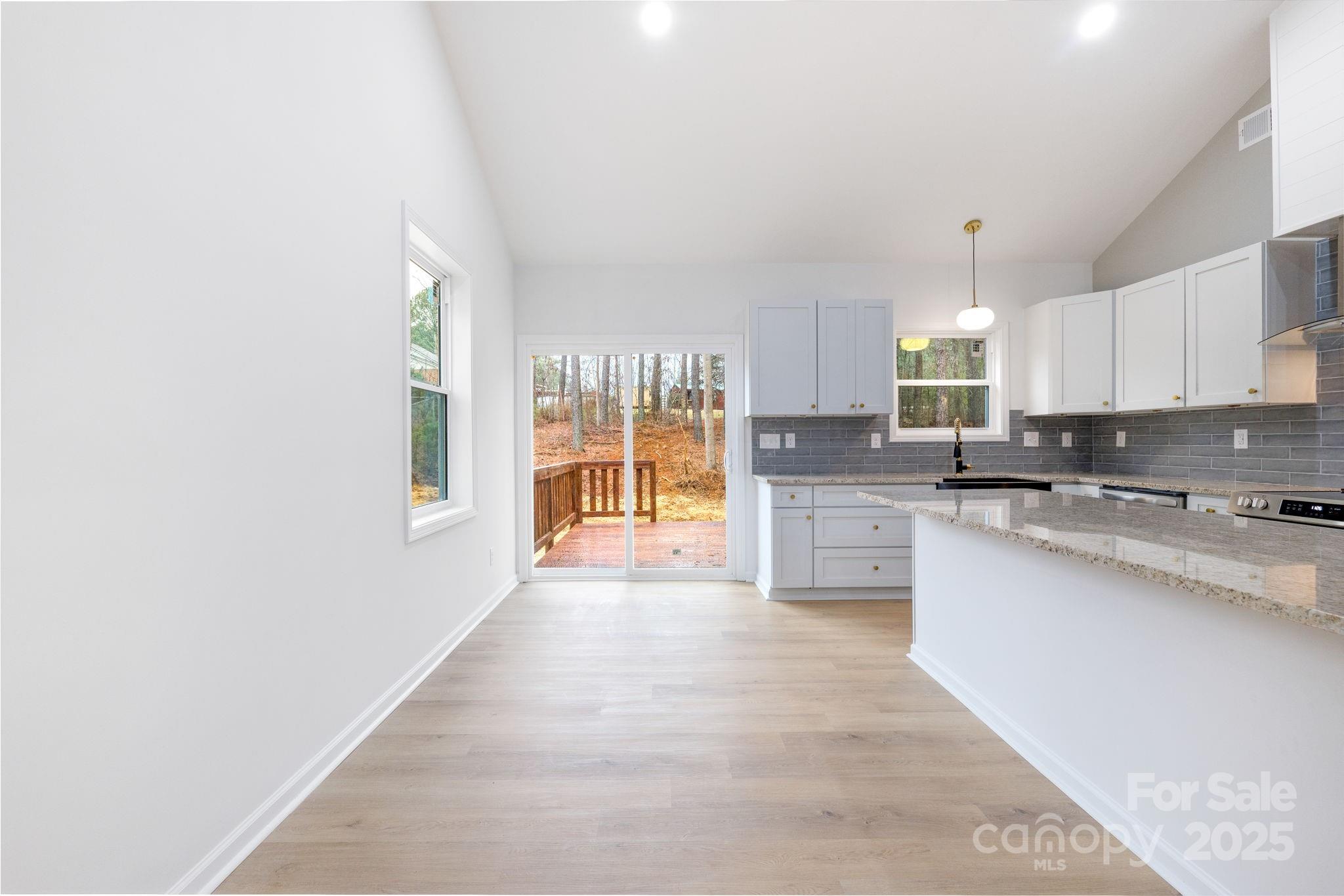 203 Bud Black Road Crouse, NC 28033 - Photo 25 of 47 a large kitchen with granite countertop a large window and a sink