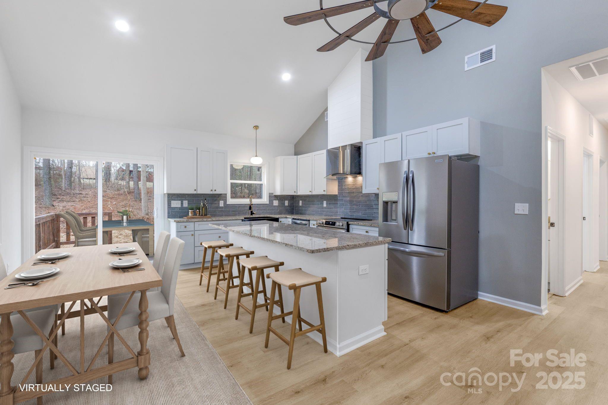 203 Bud Black Road Crouse, NC 28033 - Photo 8 of 47 a kitchen with stainless steel appliances a table chairs refrigerator and microwave
