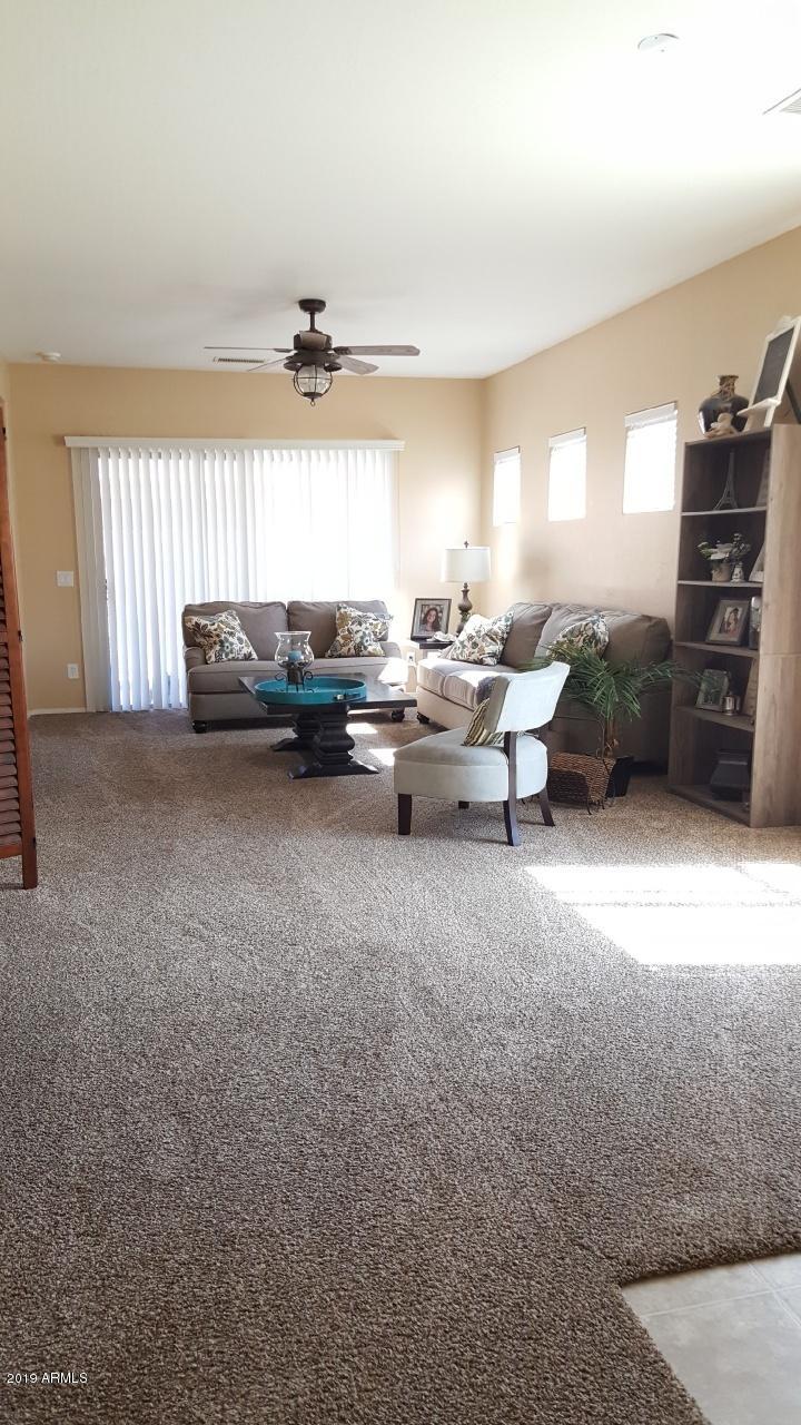 26132 West Burnett Road Buckeye, AZ 85396 - Photo 12 of 22 a living room with furniture and a window