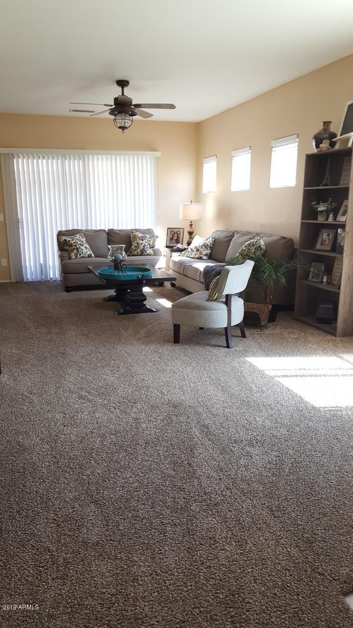 26132 West Burnett Road Buckeye, AZ 85396 - Photo 13 of 22 a living room with furniture and a large window
