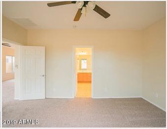 26132 West Burnett Road Buckeye, AZ 85396 - Photo 18 of 22 a view of a room with a window and a ceiling fan