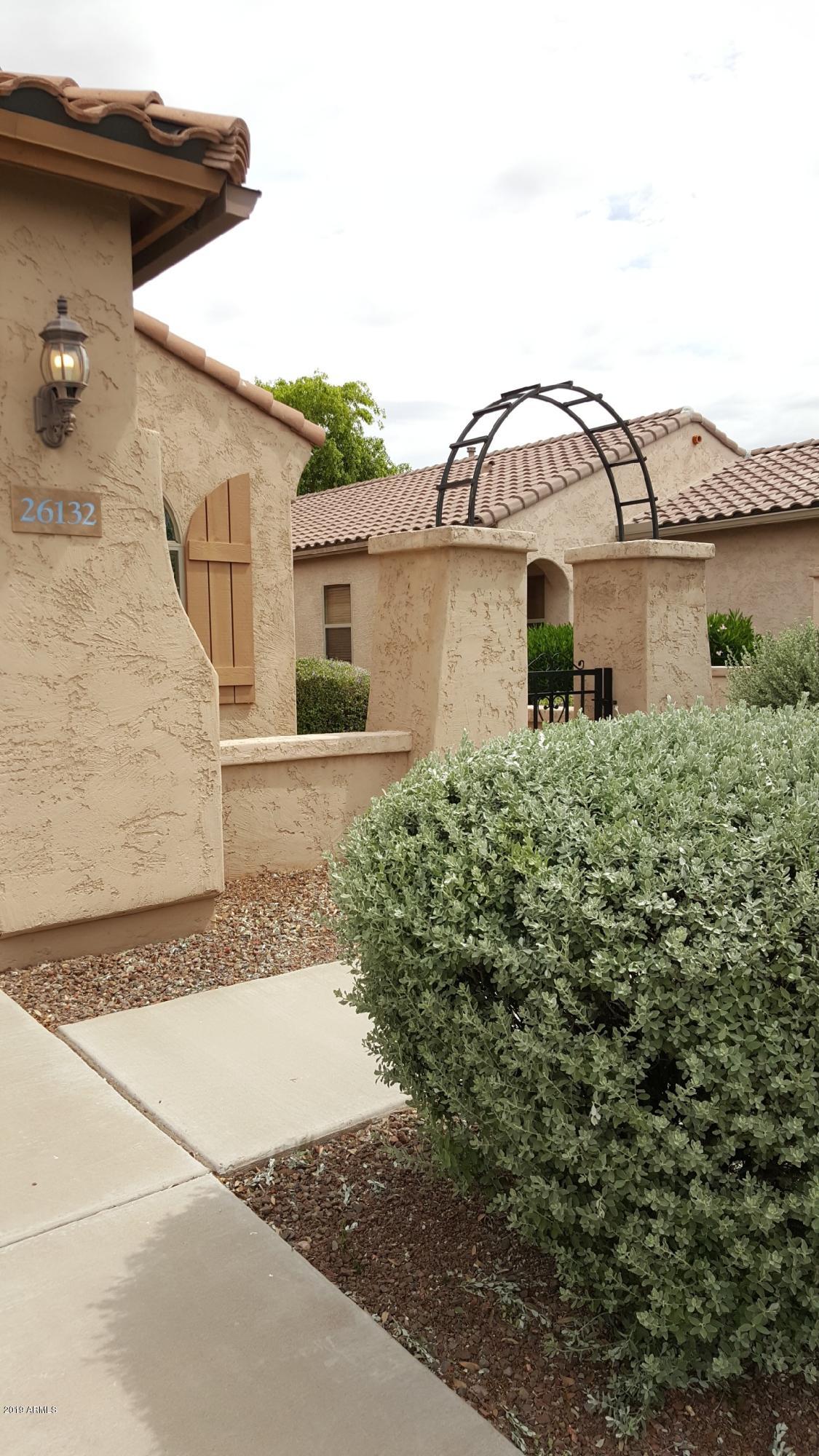 26132 West Burnett Road Buckeye, AZ 85396 - Photo 3 of 22 a front view of a house with a yard