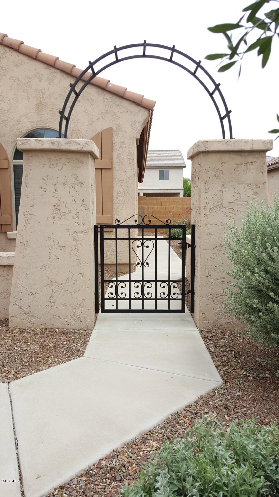 26132 West Burnett Road Buckeye, AZ 85396 - Photo 4 of 22 a view of a balcony with a potted plants