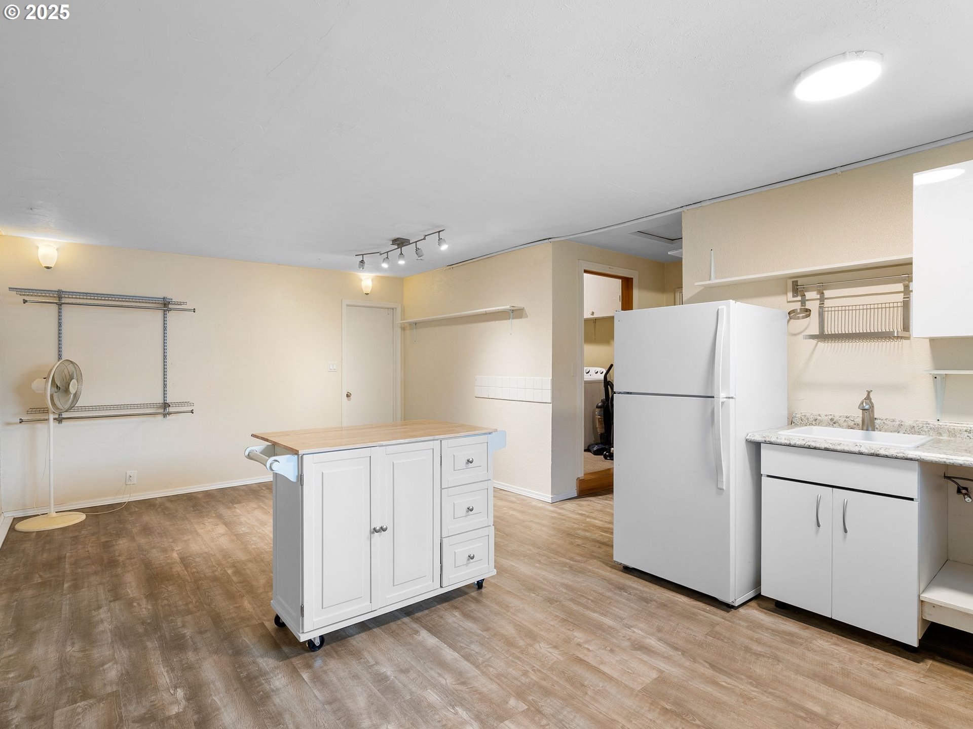1245 Northeast 118th Avenue Portland, OR 97220 - Photo 14 of 35 a kitchen with a refrigerator a sink and wooden floor