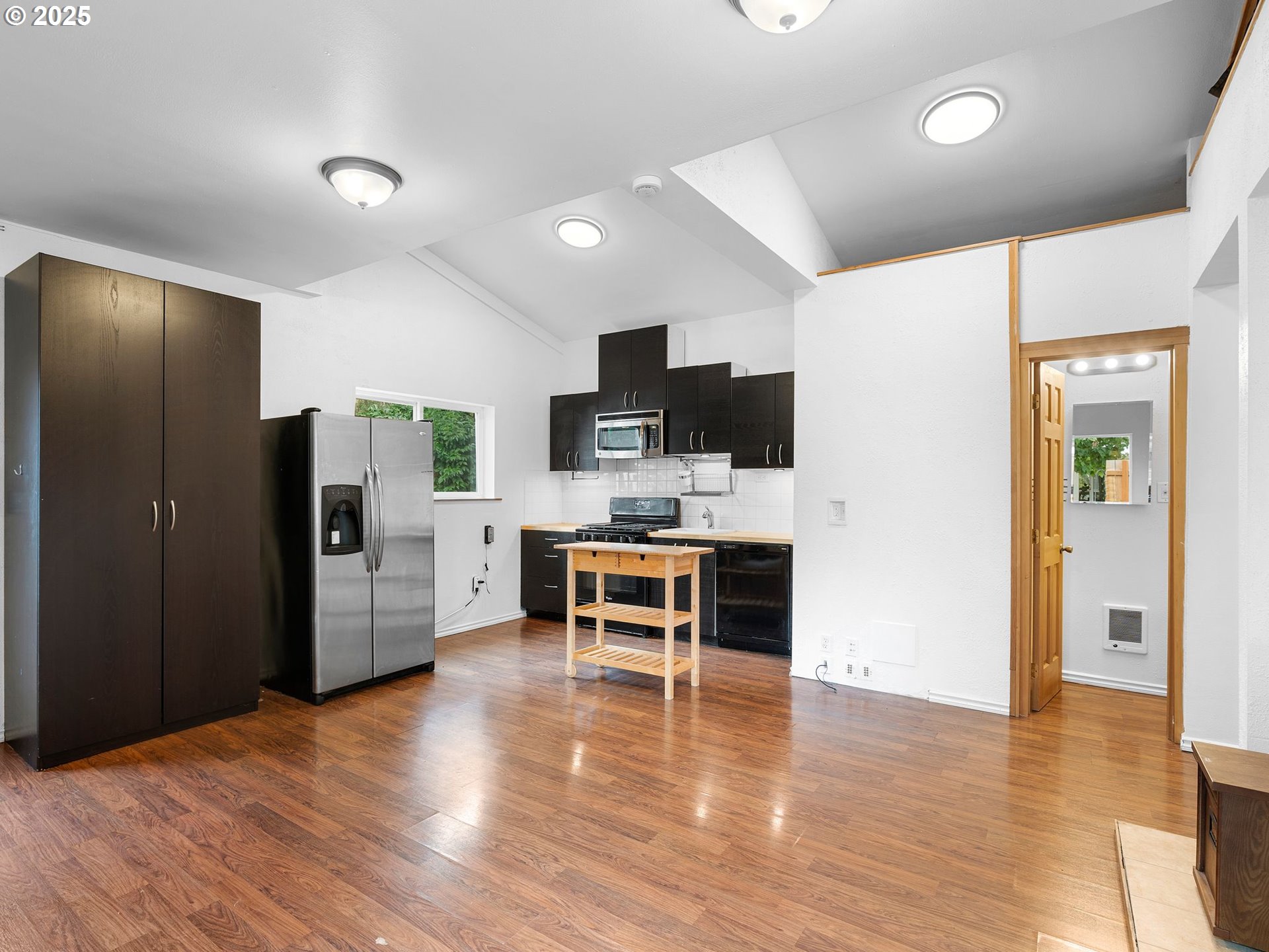 1245 Northeast 118th Avenue Portland, OR 97220 - Photo 22 of 35 a kitchen view with stainless steel appliances kitchen island granite countertop a refrigerator and a stove top oven