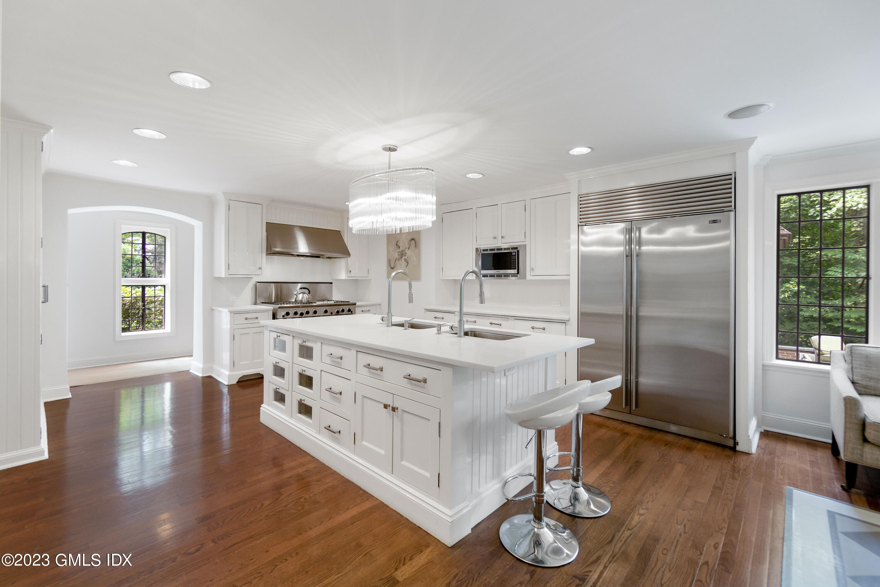 33 Midwood Road Greenwich, CT 06830 - Photo 7 of 22 a kitchen with stainless steel appliances granite countertop a refrigerator a stove and a wooden floors