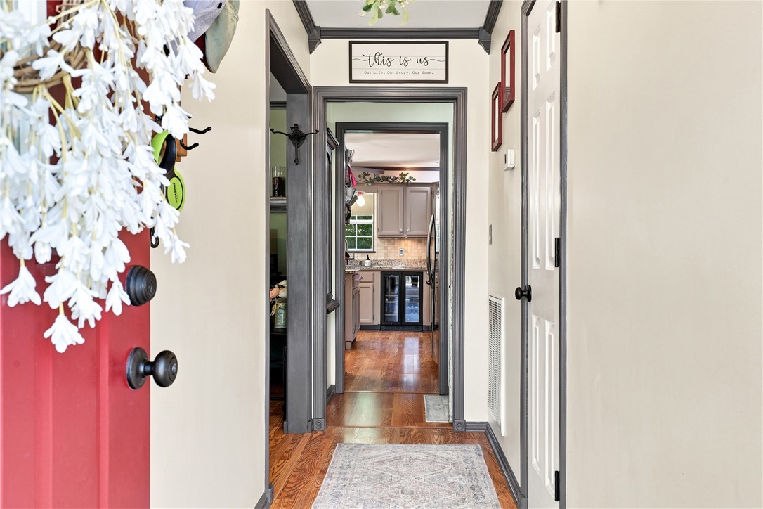 1009 Willow Run Anderson, SC 29621 - Photo 4 of 46 Rich hardwood floors and classic crown molding frame a welcoming entry hallway.