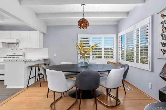 a dining room with furniture and window