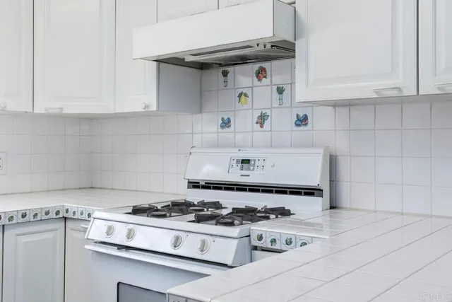a living room with furniture fireplace and a large window