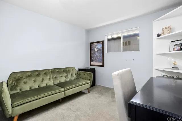 a spacious bedroom with a bed and a chandelier