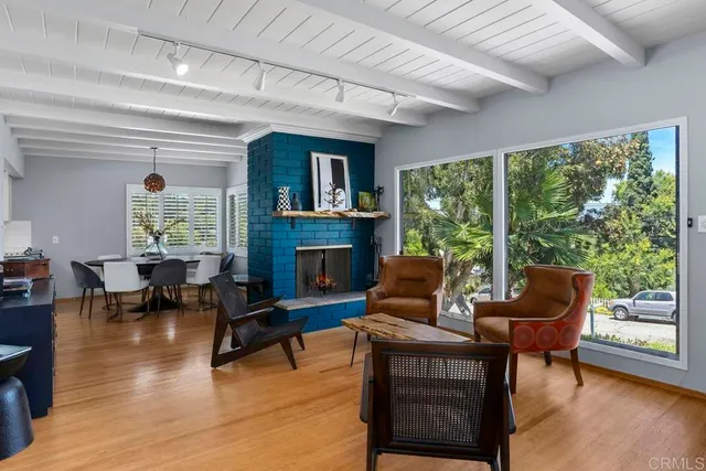 a dining room with furniture a chandelier and wooden floor