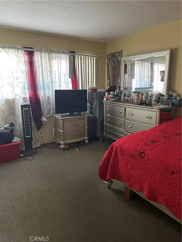 a bed room with a bed and a chair